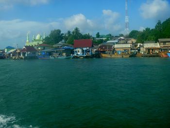 Scenic view of sea against buildings