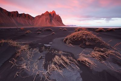 Scenic view of land against sky during sunset