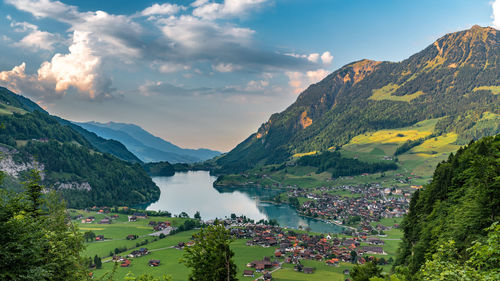 High angle view of lake and mountains against sky