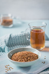 Bowl of fenugreek seeds and egyptian fenugreek yellow tea or methi dana drink