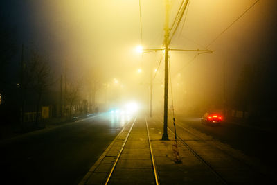 Illuminated street lights on road