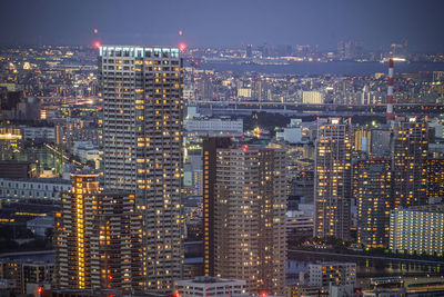 High angle view of illuminated buildings in city at night