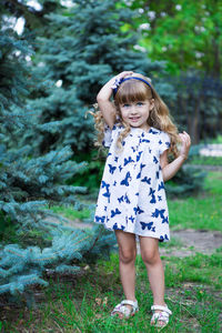 Portrait of cute girl standing against plants