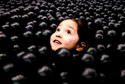 Cute girl looking up in pool ball