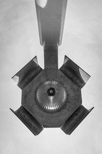 Low angle view of electric lamp hanging against sky