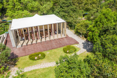 Built structure by trees and plants in garden