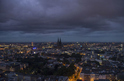 Aerial view of city against cloudy sky