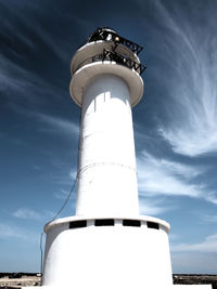 Low angle view of lighthouse against cloudy sky