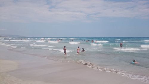 People on beach against sky