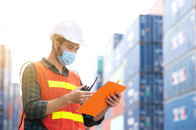 Low angle view of person working with mobile phone