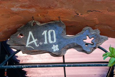 Close-up of old metal sculpture on wall