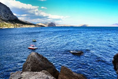 Scenic view of sea with mountain in background