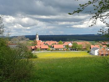 Houses on landscape against sky