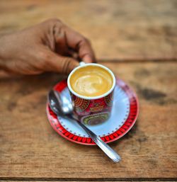 Midsection of coffee cup on table