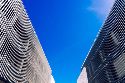 Low angle view of buildings against clear blue sky