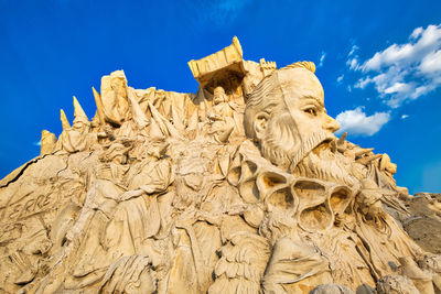 Low angle view of statue against blue sky