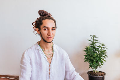 Portrait of young man against wall