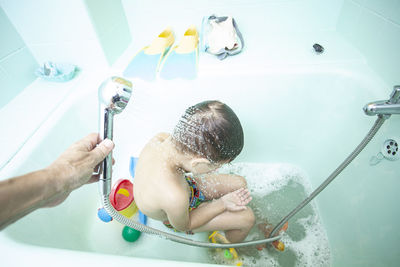 Siblings playing in bathroom at home