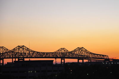 Low angle view of silhouette bridge against sky during sunset