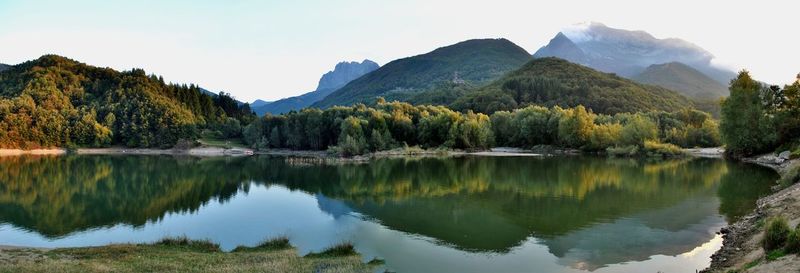 Scenic view of lake and mountains against sky