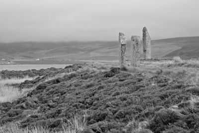 Abandoned built structure on land by sea against sky