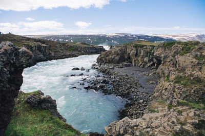 Scenic view of sea and rocks against sky
