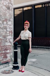 Full length of woman sitting on wall