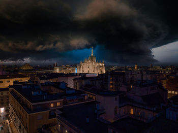 Aerial view of piazza duomo in front of the gothic cathedral in the center of milan at night.