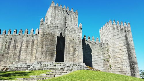 Low angle view of historical building against blue sky