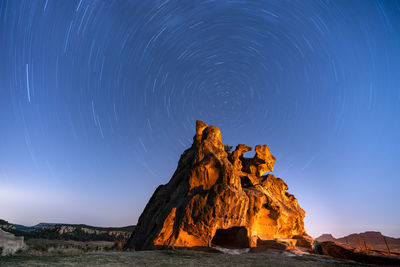 Rock formations against sky at night