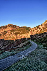 Scenic view of mountains against clear blue sky