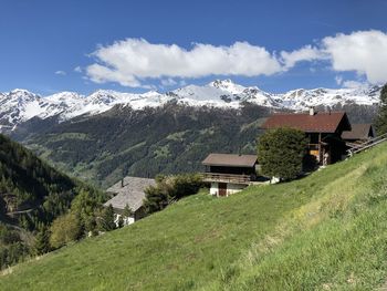 Scenic view of houses and mountains against sky