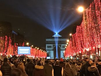 Group of people in illuminated building at night