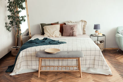 Table and chairs on bed against wall at home