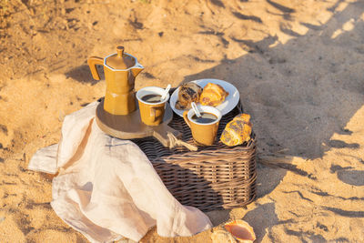 High angle view of drinks on sand at beach