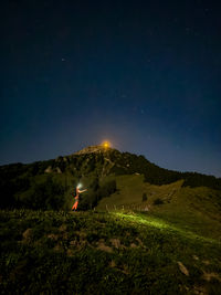 Scenic view of landscape against sky at night