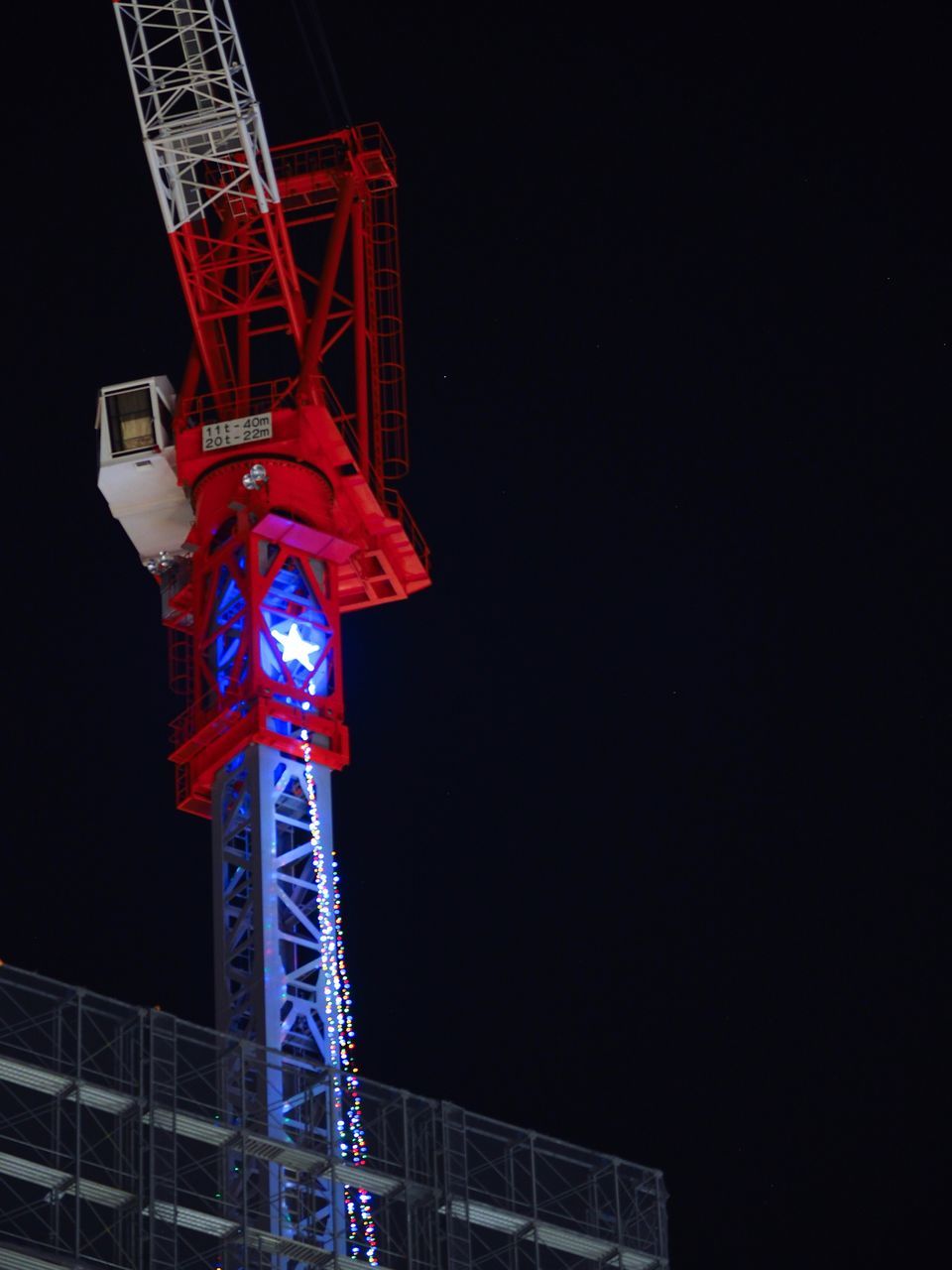 night, low angle view, illuminated, copy space, built structure, architecture, no people, construction site, outdoors, clear sky, building exterior, black background, sky