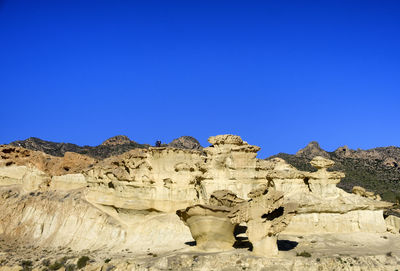 Rock formations against blue sky