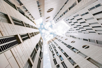 From below of tall modern residential buildings with concrete facade located in barcelona