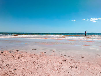 Scenic view of beach against blue sky