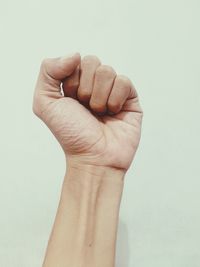 Close-up of human hand against white background