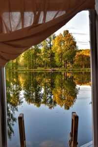 Reflection of trees on lake against sky