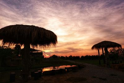 Scenic view of sunset over land against sky