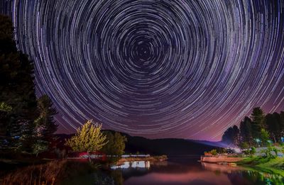 Scenic view of lake against sky at night