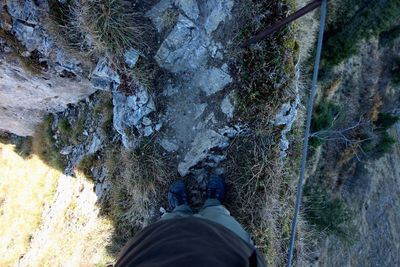 Low section of person standing on rock