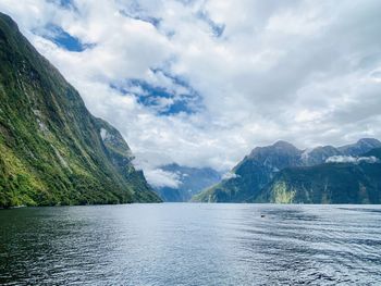 Scenic view of lake and mountains against sky