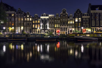 Reflection of buildings in water at night