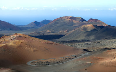 Scenic view of arid landscape against sky