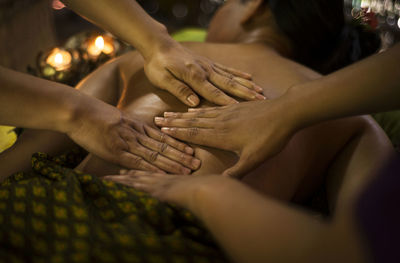 Midsection of woman getting herbal message at spa