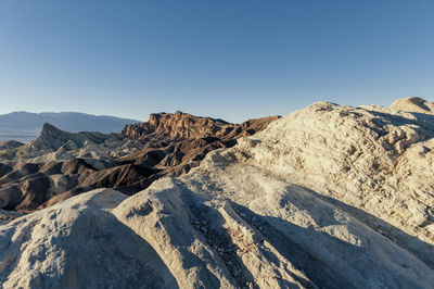 Scenic view of mountains against clear blue sky